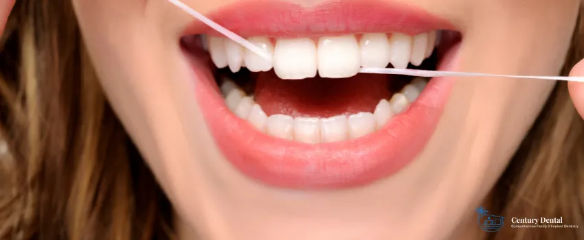 CD - Close up shot of a woman flossing her front teeth