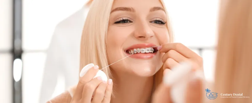 CD - Woman wearing braces flossing her teeth