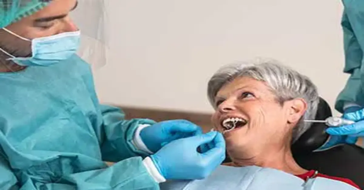 A dentist checking a lady's teeth